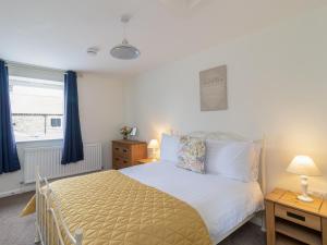 a bedroom with a bed and a window at Foxglove - Uk51200 in Staintondale