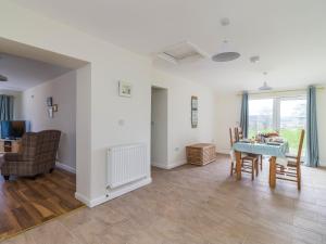 a living room with a blue table and chairs at Foxglove - Uk51200 in Staintondale