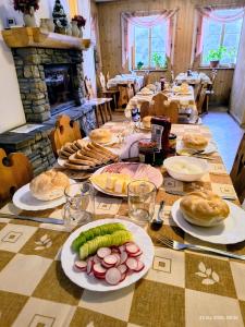 a long table with plates of food on it at CHAŁUPA Pokoje Gościnne in Poronin