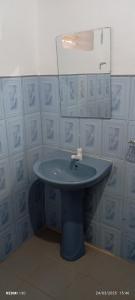 a blue sink in a bathroom with a mirror at Me-Family in Matale +50 photos