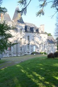 an old stone house with a large yard at Le Château de La Coste in Saint-Julien