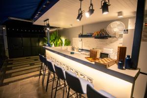 a bar with chairs and a counter in a room at Baan Rot Fai Krabi Platform 3 in Ao Nam Mao