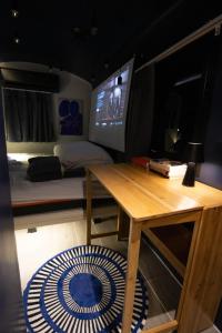 a room with a desk and a bed and a television at Baan Rot Fai Krabi Platform 3 in Ao Nam Mao