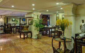 ein Restaurant mit Tischen und Stühlen in einem Zimmer in der Unterkunft Classic Street Hotel in Hanoi