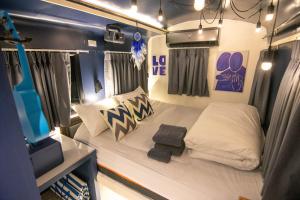 a small room with a bed in a trailer at Baan Rot Fai Krabi Platform 3 in Ao Nam Mao +57 photos