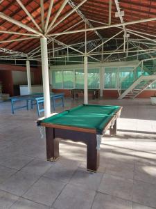 a ping pong table in a room with two tables at Flat 207 Villa Hípica - Gravatá in Gravatá