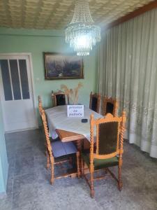 a dining room table with a sign on it at Apartment PER DAY in Vrbas +12 photos
