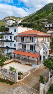 a large white building with a parking lot at Villa Evelyn Free Parking in Vlorë