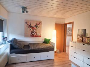 a bedroom with a bed with a deer painting on the wall at Himmelsnest in Bad Wildbad