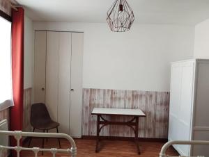a dining room with a table and a chair at Gîte de St Jean in Verdalle