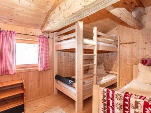 a bedroom with a bunk bed in a log cabin at Almhütte Bairau Kaser in Lofer