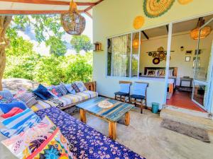 a living room with a couch and a table at Garnet Yala Beach in Kirinda