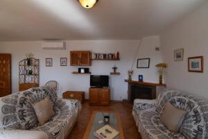 a living room with two couches and a tv at Villa La Frasca with private Pool in Corumbela