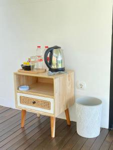 a wooden table with a tv on top of it at villa heve glamping in Kaliurang