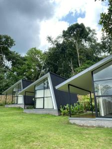 a house with a black roof and windows at villa heve glamping in Kaliurang