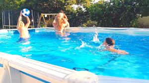 a group of people playing with a volley ball in a swimming pool at CASA MIGUEL y SALLY in Villanueva de las Manzanas