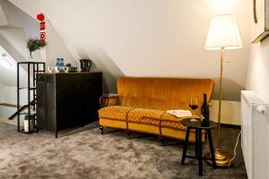 a living room with a yellow couch and a table at Dworek Modrzewiowy in Kraśnik