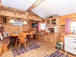 a kitchen with a table and chairs in a cabin at Almhütte Bairau Kaser in Lofer +15 photos