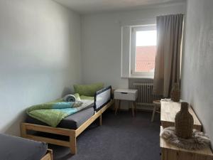 a small room with a bed and a window at Ferienwohnung Landliebe in Pinswang