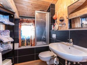 a bathroom with a sink and a toilet at Almhütte Bairau Kaser in Lofer
