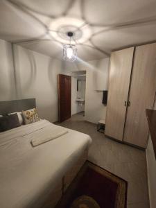 a bedroom with a bed and a ceiling fan at The LUX in Nairobi