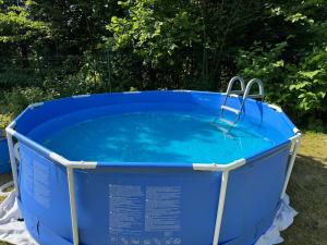 a blue bucket of water sitting on the grass at Roubenka Liduška in Mikulovice