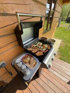 a grill on a deck with food on it at Roubenka Liduška in Mikulovice