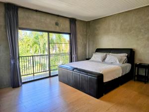 a bedroom with a bed and a large window at Anusorn Villas & Garden Oasis - Peaceful Chiang Mai Hideaway in Ban Ton Chok +58 photos