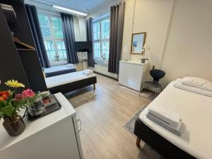 a room with a bedroom with a bed and a couch at Hostel Hermanni in Kuopio