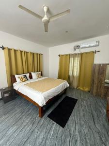 a bedroom with a bed and a ceiling fan at Patnem Bliss in Canacona
