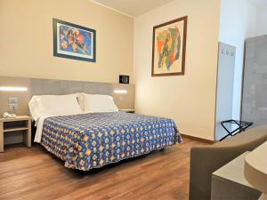 a hotel room with a bed and a couch at Hotel Ornella in Lido di Jesolo