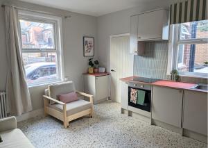a kitchen with a chair and a table and a counter at Tranquil flat in vibrant Nether Edge in Nether Edge +1 photo
