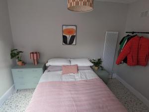 a bedroom with a bed with a pink blanket at Tranquil flat in vibrant Nether Edge in Nether Edge