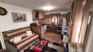 a living room with a couch and a kitchen at YNA House in Bucharest