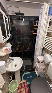 a small bathroom with a sink and a toilet at YNA House in Bucharest +9 photos