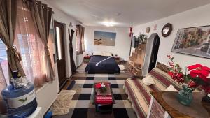 a living room with a bed and a checkered floor at YNA House in Bucharest