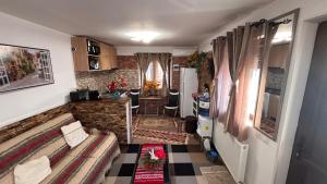 a living room with a couch and a kitchen at YNA House in Bucharest