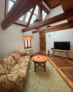 a living room with a couch and a table at Apartmán na statku in Teplice