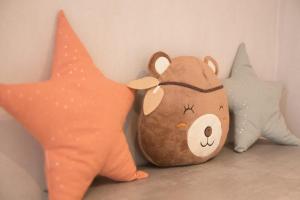 a group of stuffed animals sitting next to a wall at Le nid Saint Jean apartment in the heart of the city in Bayeux