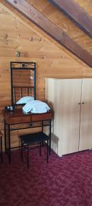 a bed in a room with a wooden ceiling at mezonetaki in Karpenisi +4 photos