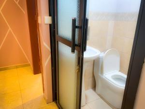 a bathroom with a toilet and a door with a door at Résidence TB in Douala +37 photos
