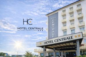 a hotel sign in front of a building at Hotel Centrale FRONTE MARE in Milano Marittima