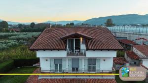 a yellow tape surrounds a white house with a roof at La Dimora Certosina in Padula