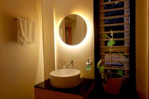 a bathroom with a sink and a mirror at Skylark Home in Mananthavady +36 photos
