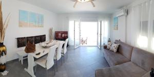 a living room with a table and a couch at Beachfront villa Ioanna in Kokkari