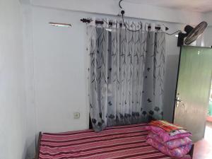 a bedroom with a bed with a curtain in a room at Great Resort in Nikawatawana