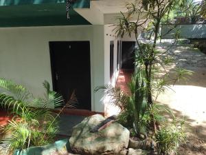 a house with a black door and some plants at Great Resort in Nikawatawana