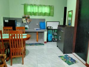 a kitchen and dining room with a table and chairs at Urban Serenity Home in Puerto Princesa City +3 photos