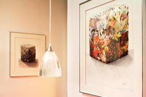 a picture of a painting and a candle on a wall at Villa Diana in Molsheim