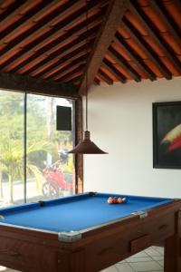a pool table in a living room with a ceiling at Pousada Mirante dos Papagaios in Búzios